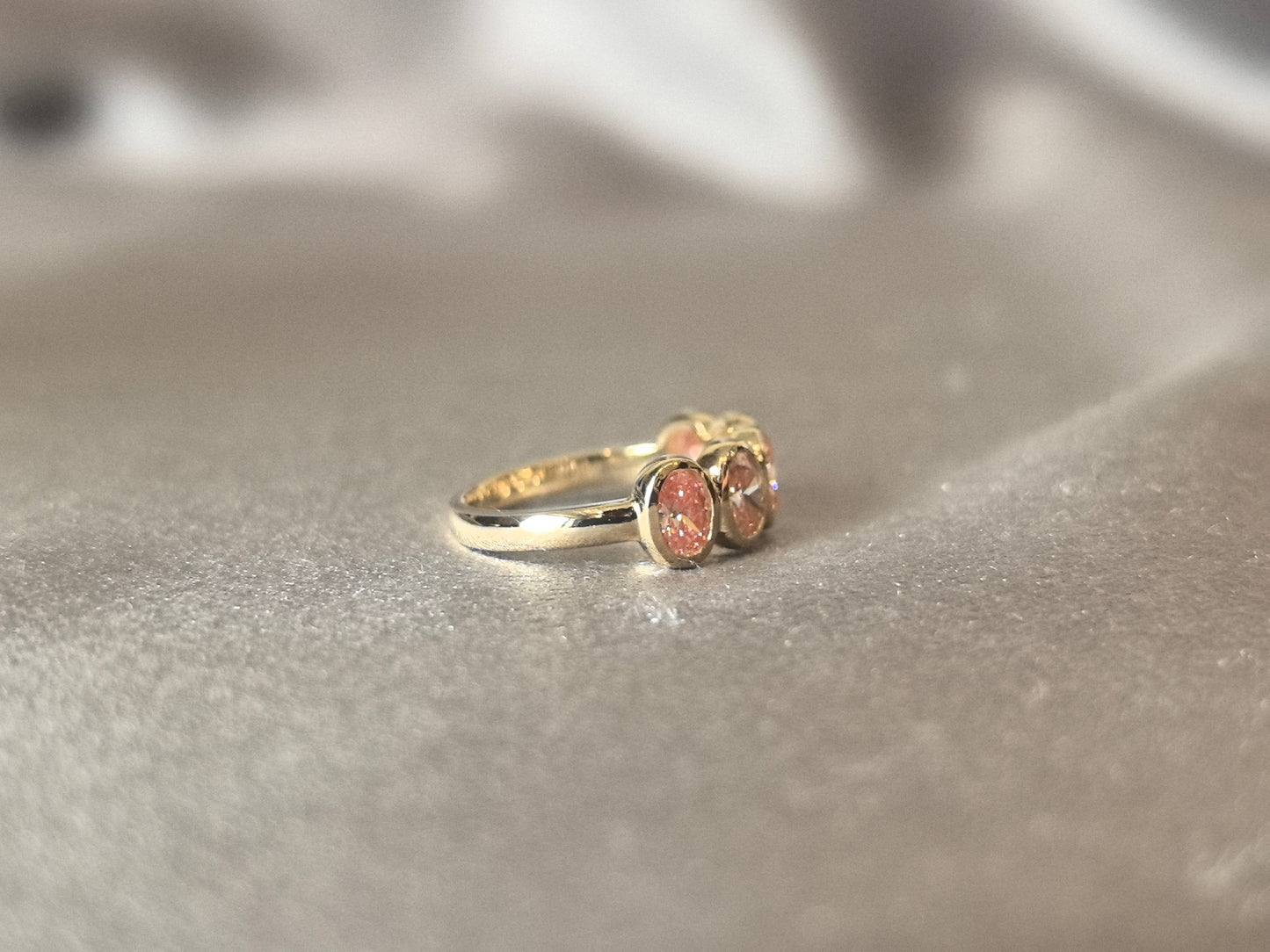 Oval-cut pink lab diamond half eternity ring - Bezel-set champagne diamond wedding band - Scratch-resistant setting