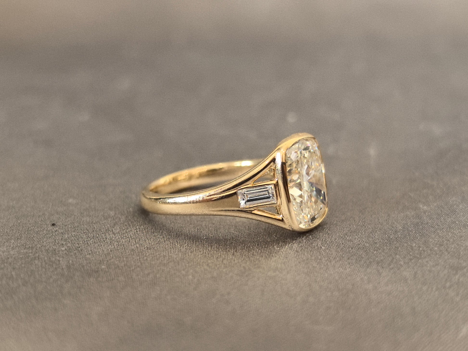 4-carat cushion cut, with emerald side stones on both sides, bezel setting, vintage design