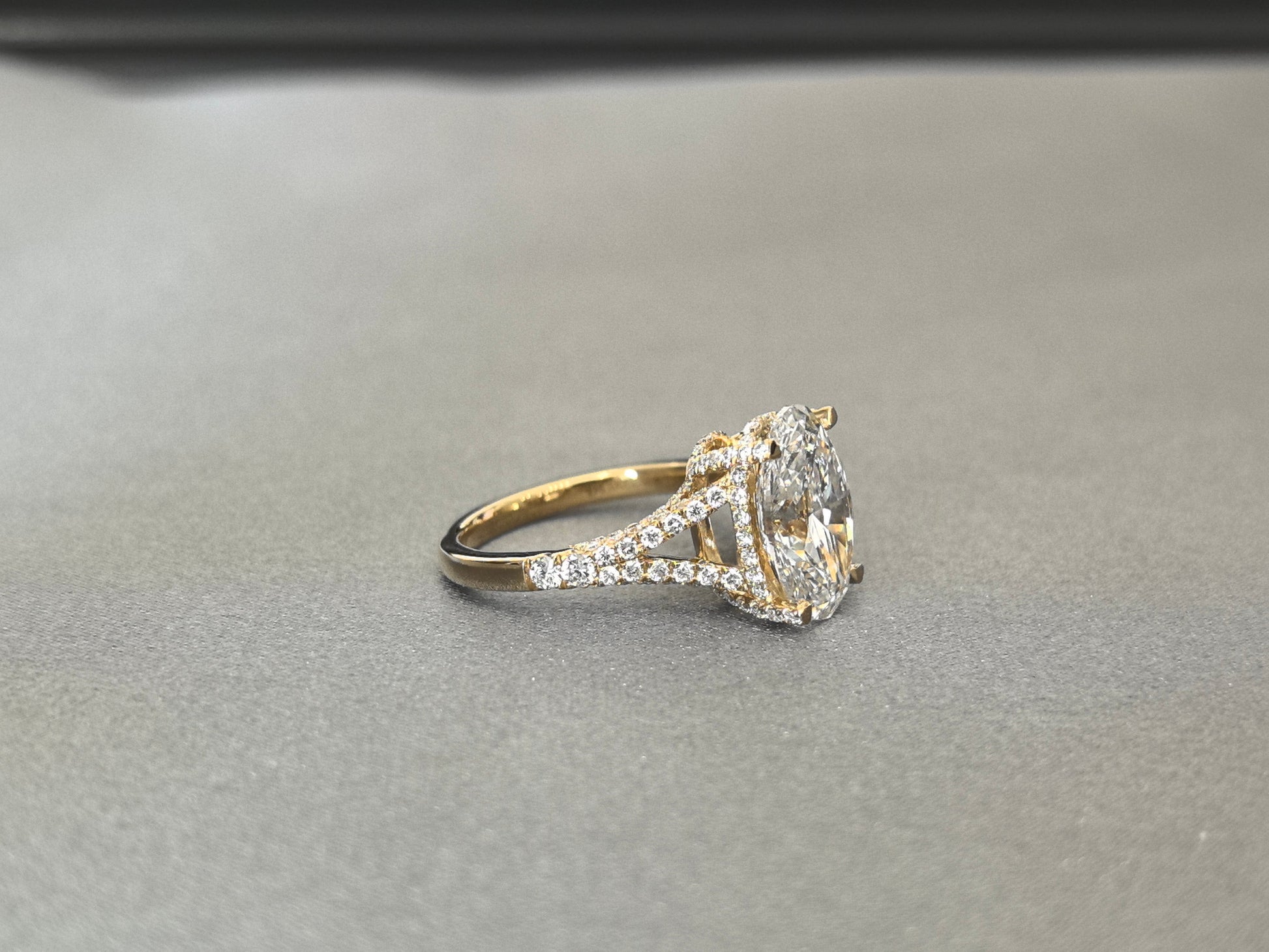 Oval Cut Four-Prong Solitaire - Pave Set Diamond Shank - Hidden Halo & Half Pavé Band