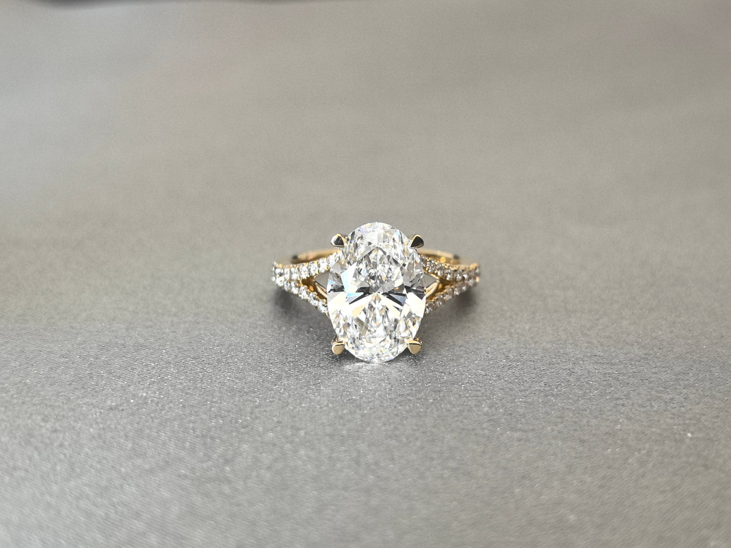 Oval Cut Four-Prong Solitaire - Pave Set Diamond Shank - Hidden Halo & Half Pavé Band