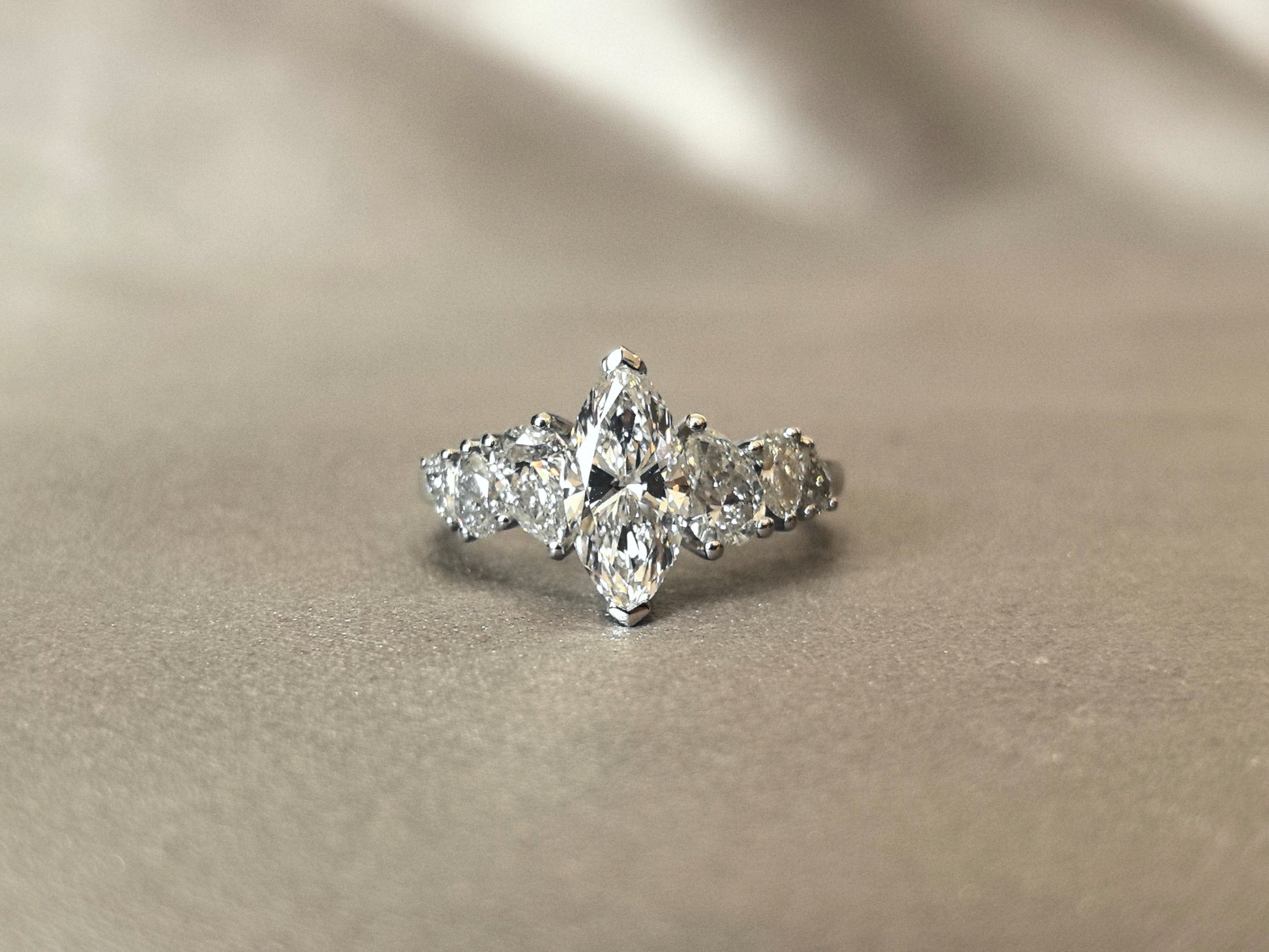 Marquise-shaped lab diamond ring - Upside-down teardrop design on both sides - Pear-shaped side stones