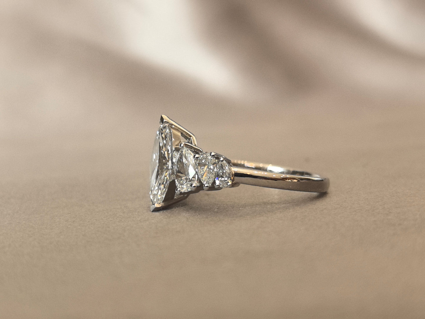 Marquise-shaped lab diamond ring - Upside-down teardrop design on both sides - Pear-shaped side stones