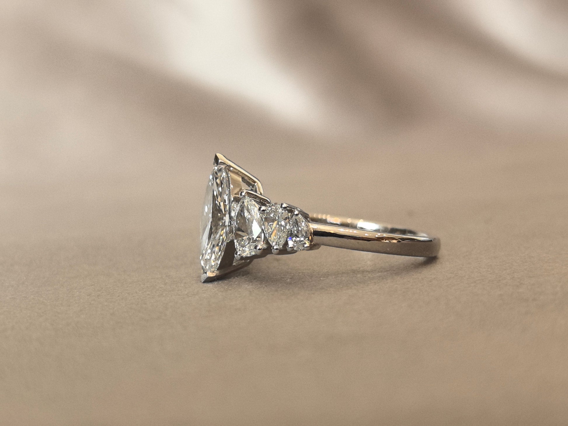 Marquise-shaped lab diamond ring - Upside-down teardrop design on both sides - Pear-shaped side stones