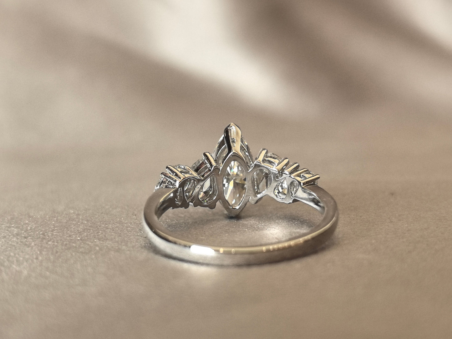 Marquise-shaped lab diamond ring - Upside-down teardrop design on both sides - Pear-shaped side stones