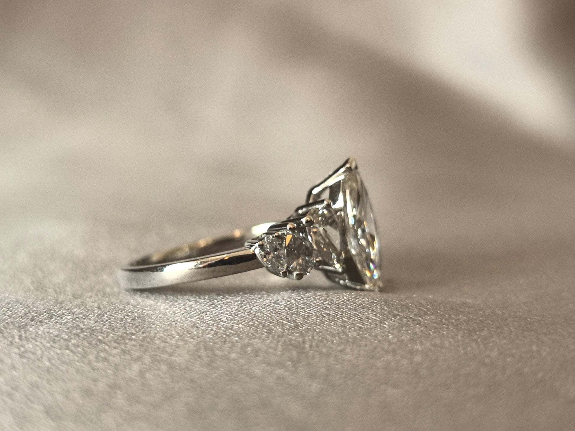 Marquise-shaped lab diamond ring - Upside-down teardrop design on both sides - Pear-shaped side stones
