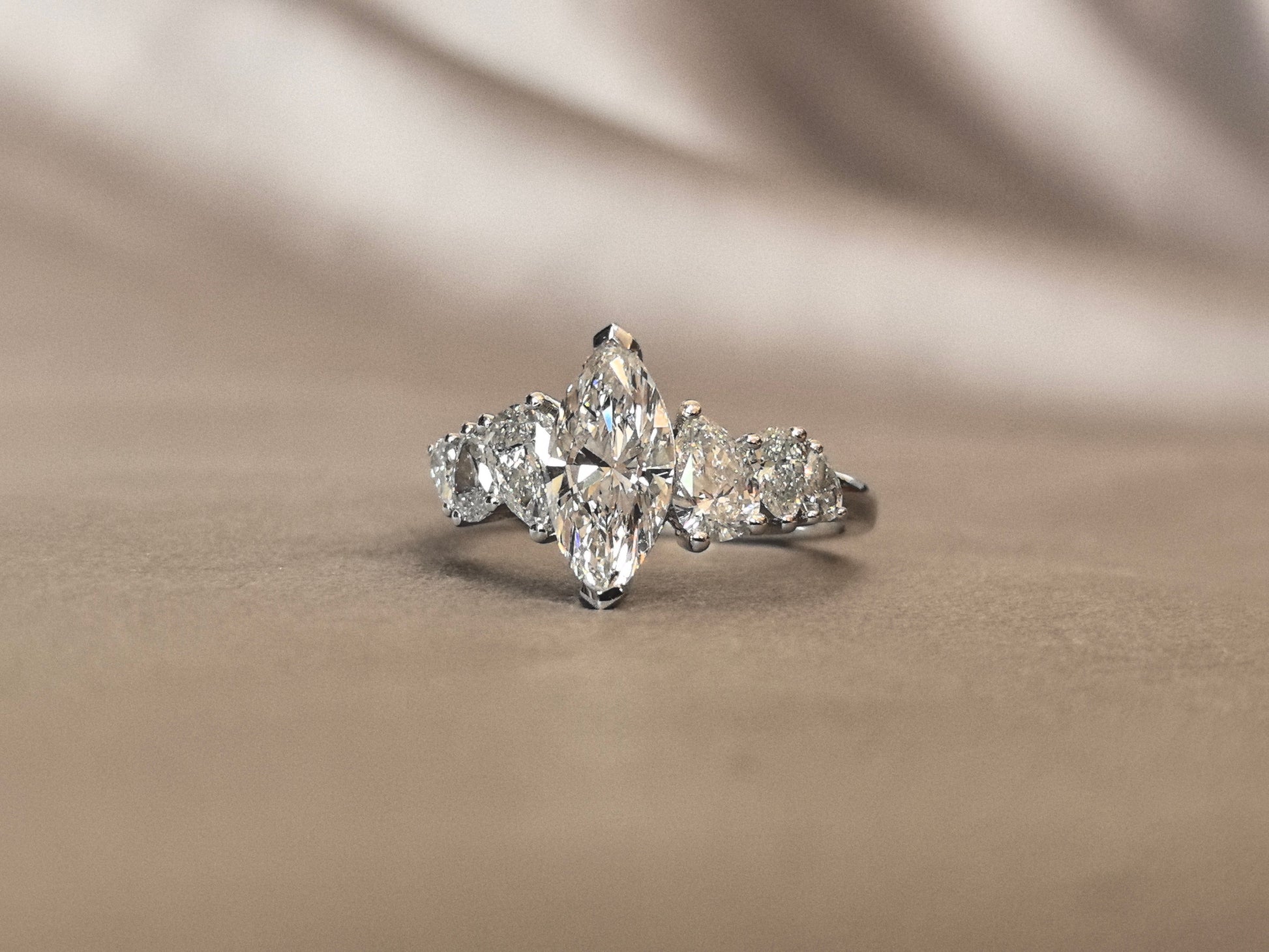 Marquise-shaped lab diamond ring - Upside-down teardrop design on both sides - Pear-shaped side stones