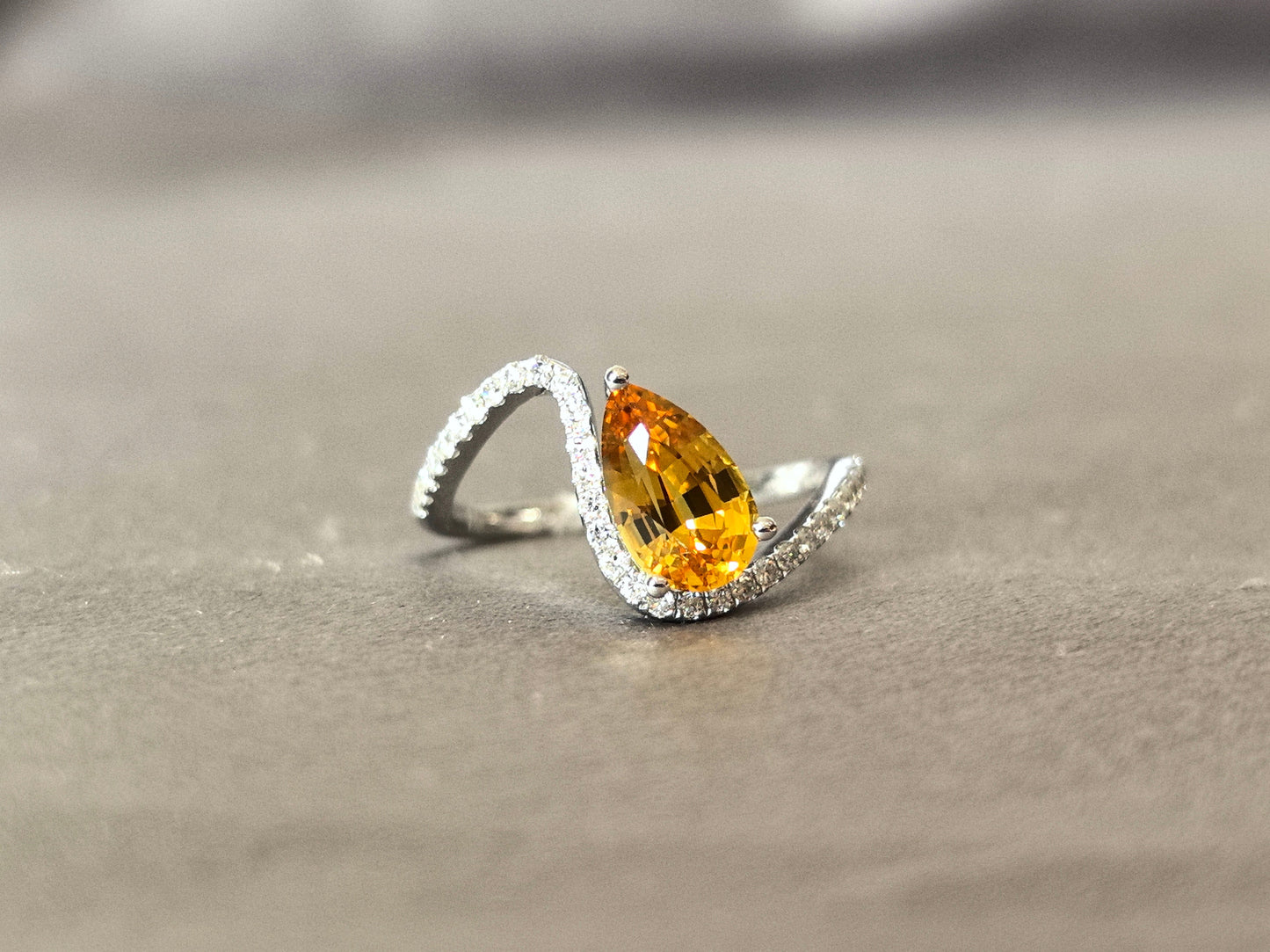 yellow pear-shaped lab-grown diamond pinky ring with small diamonds set on the band