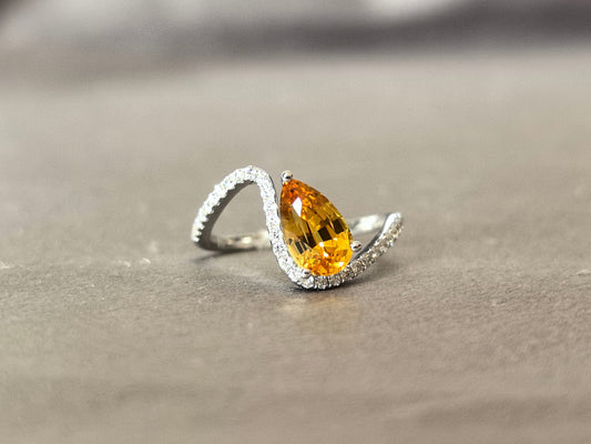yellow pear-shaped lab-grown diamond pinky ring with small diamonds set on the band