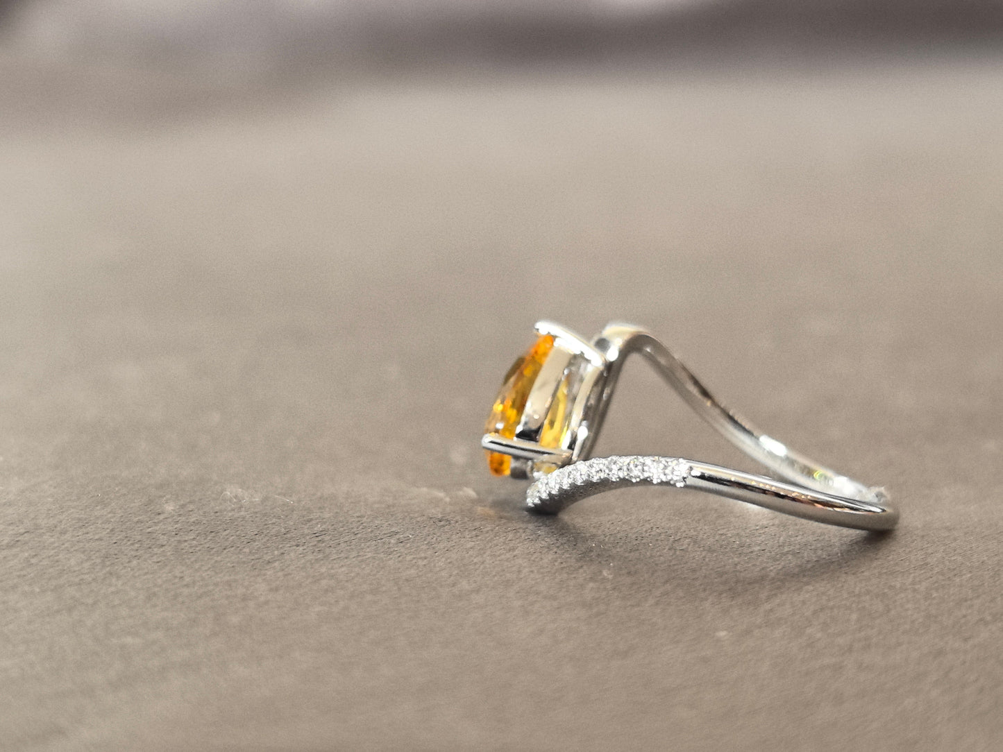 yellow pear-shaped lab-grown diamond pinky ring with small diamonds set on the band