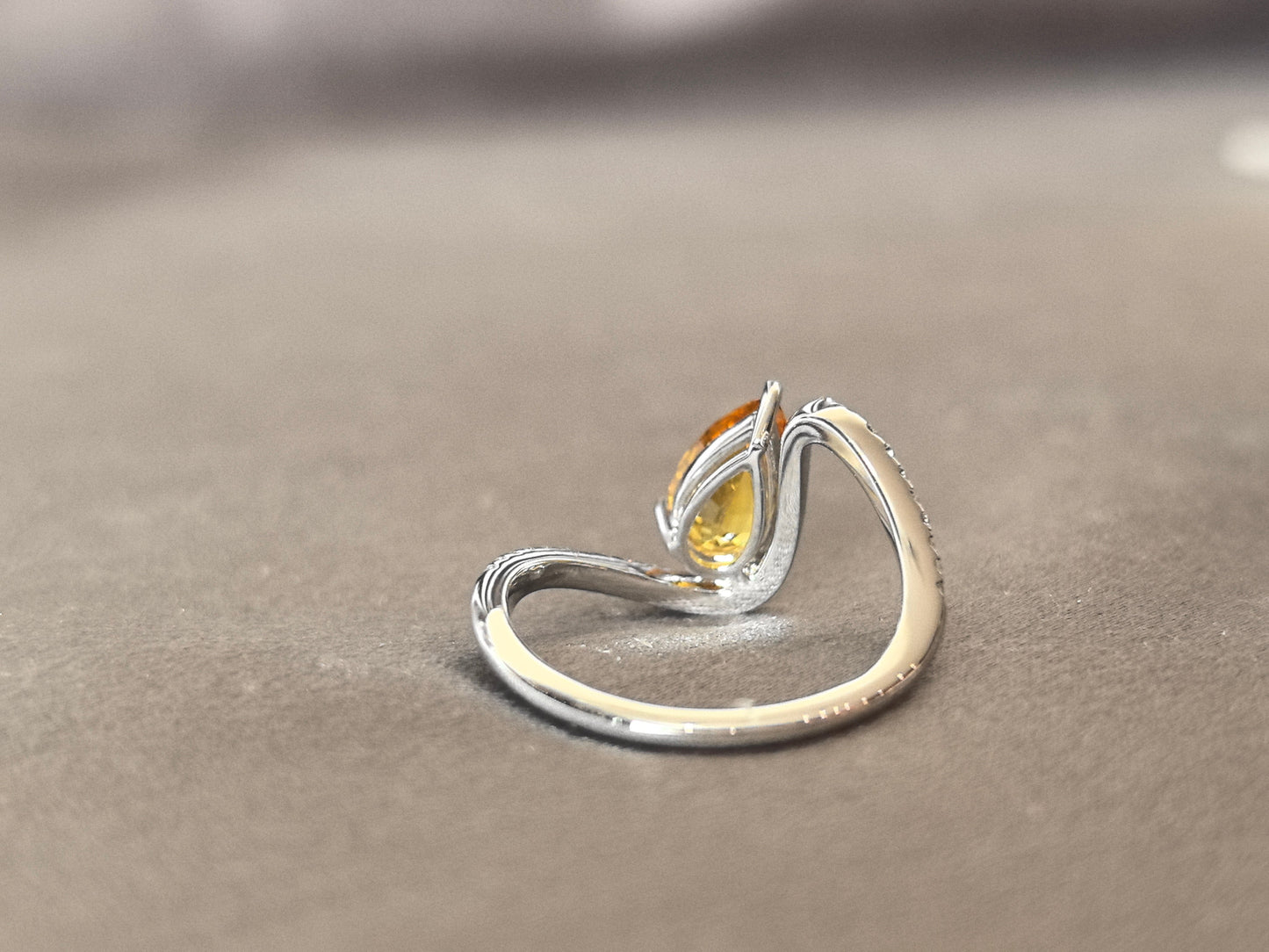 yellow pear-shaped lab-grown diamond pinky ring with small diamonds set on the band