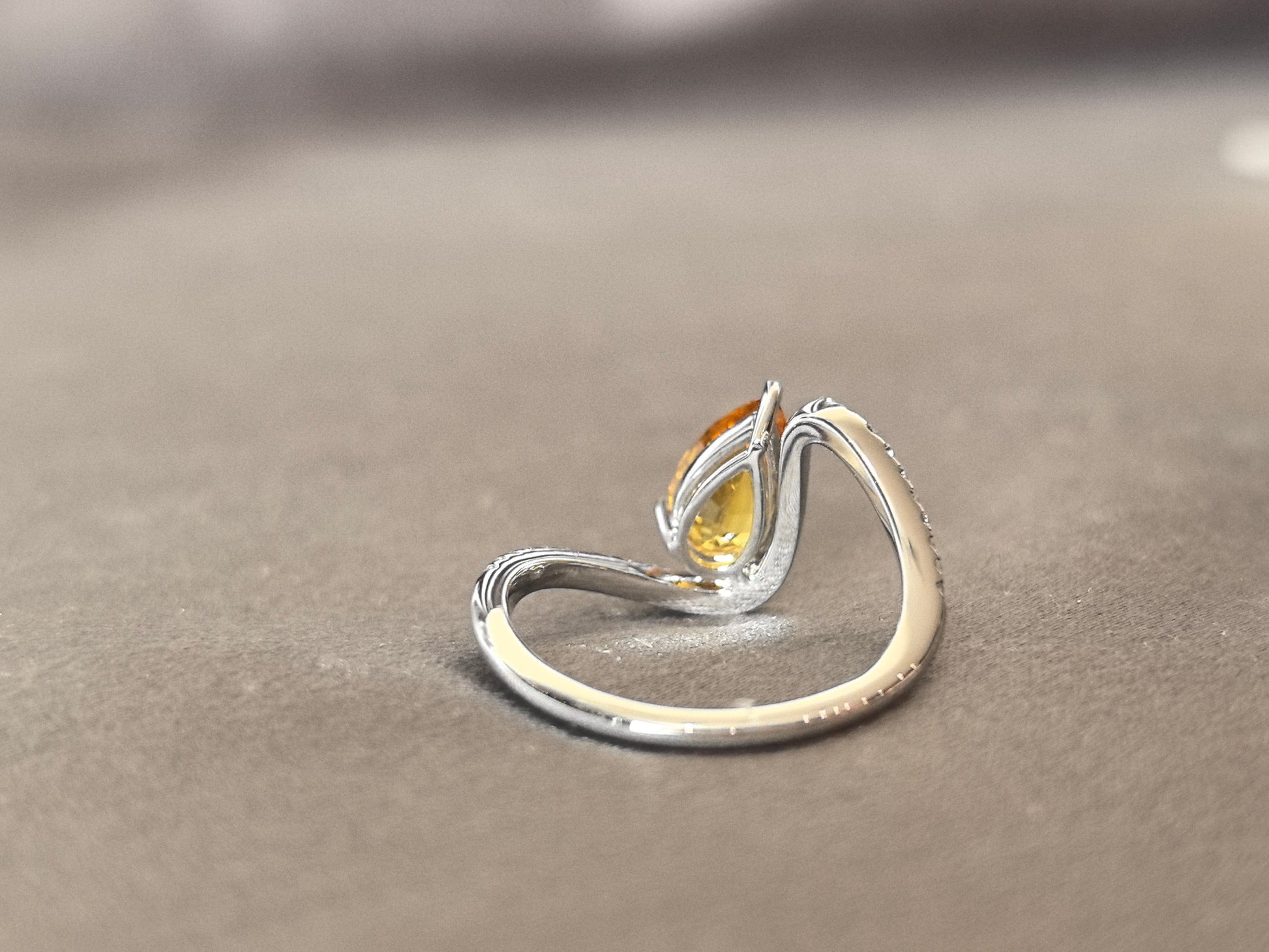 yellow pear-shaped lab-grown diamond pinky ring with small diamonds set on the band