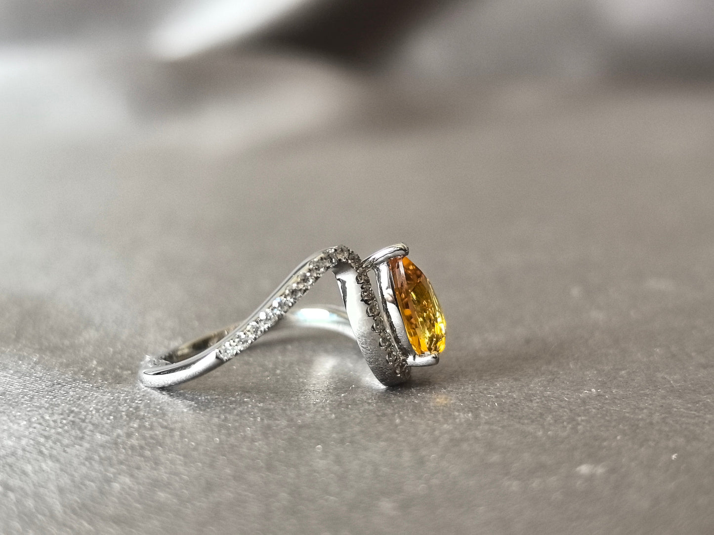 yellow pear-shaped lab-grown diamond pinky ring with small diamonds set on the band