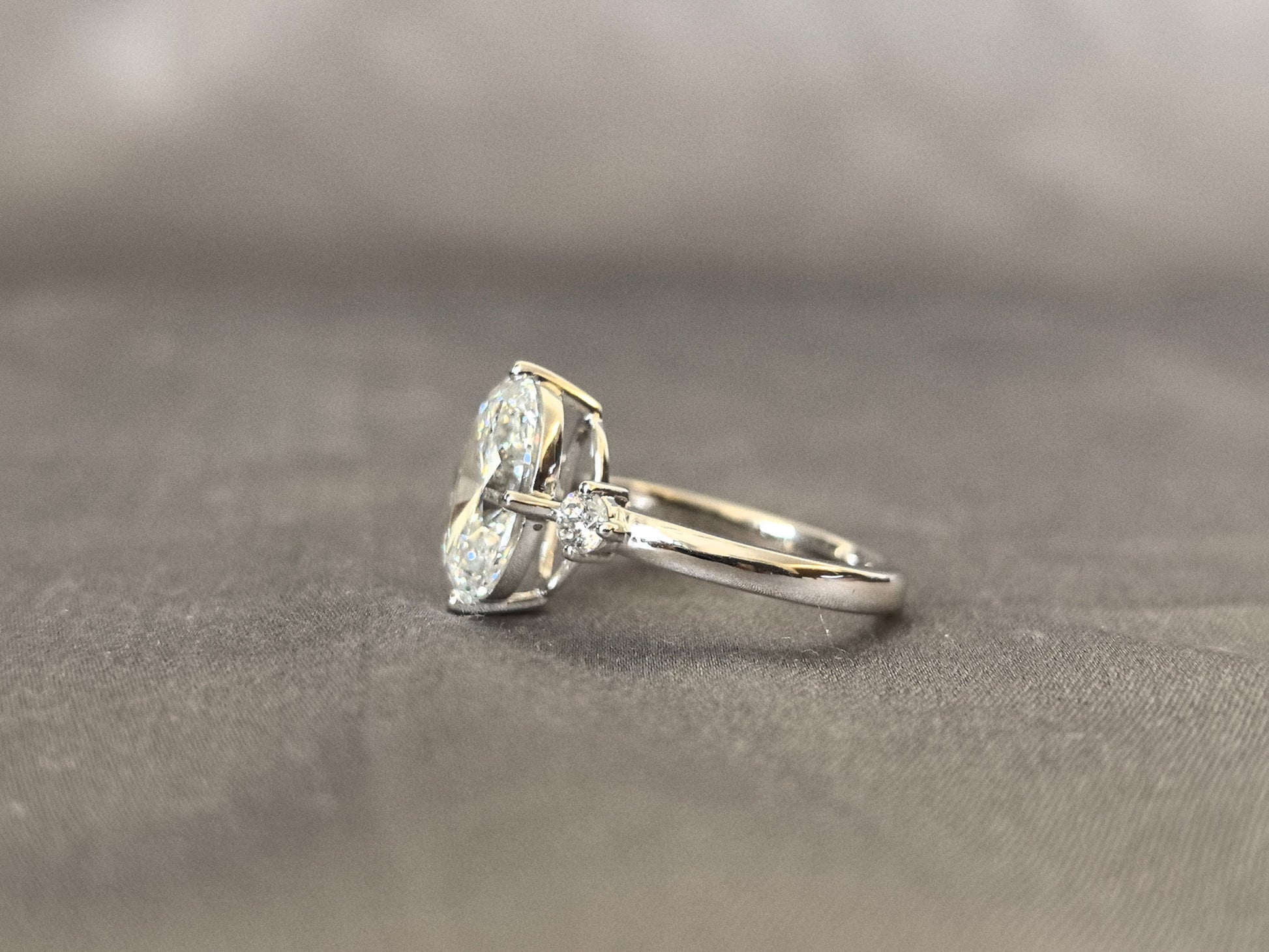 Oval Lab Diamond Three-Stone Ring - Round Side Diamonds - Four-Claw Prong Setting
