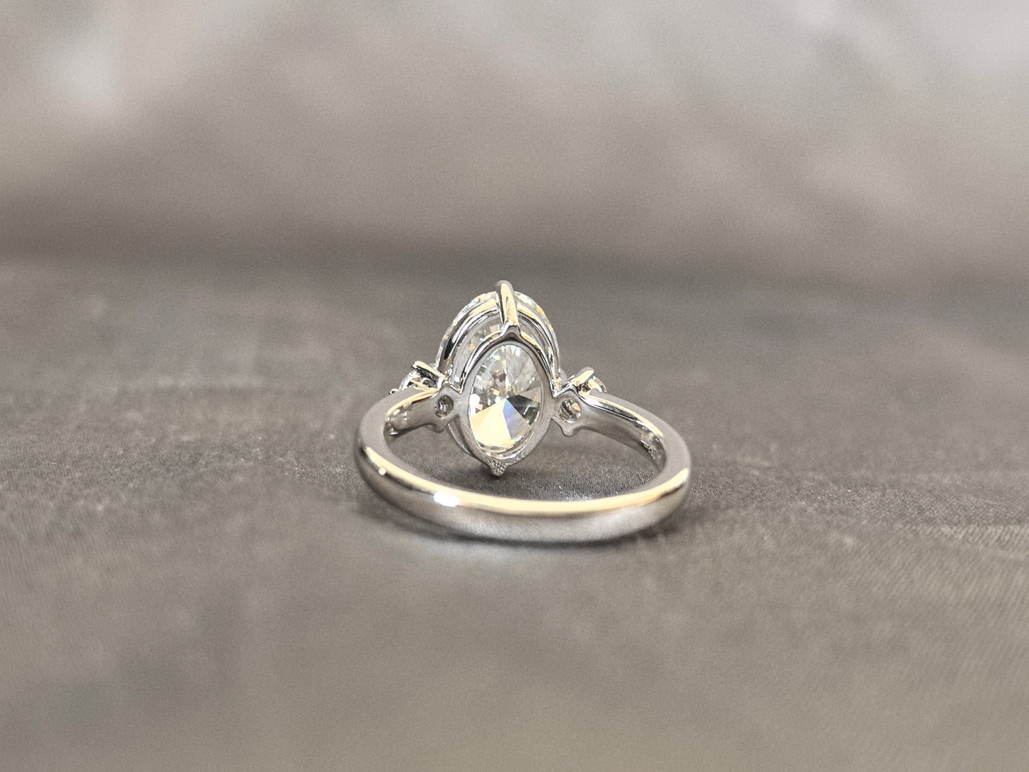 Oval Lab Diamond Three-Stone Ring - Round Side Diamonds - Four-Claw Prong Setting