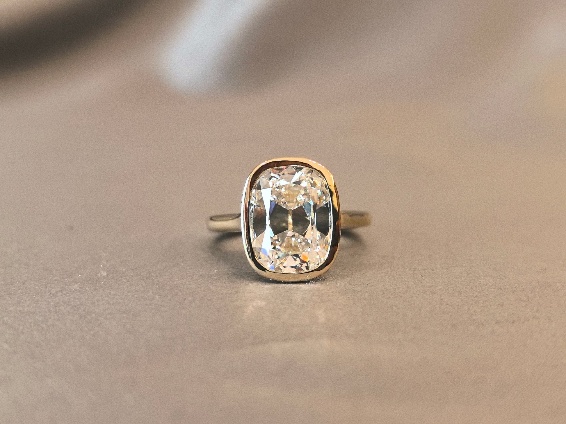 7-carat old mine cut elongated cushion bezel setting In 14K yellow gold