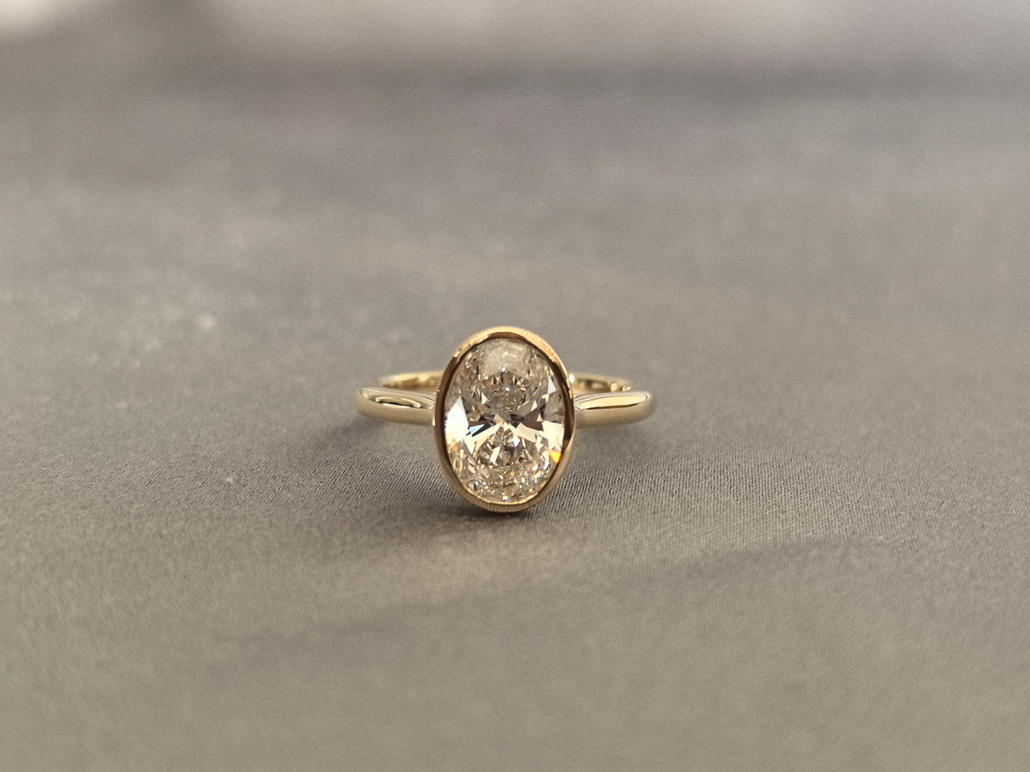 Oval-cut lab diamond solitaire ring - Bezel-set - Low-profile oval diamond