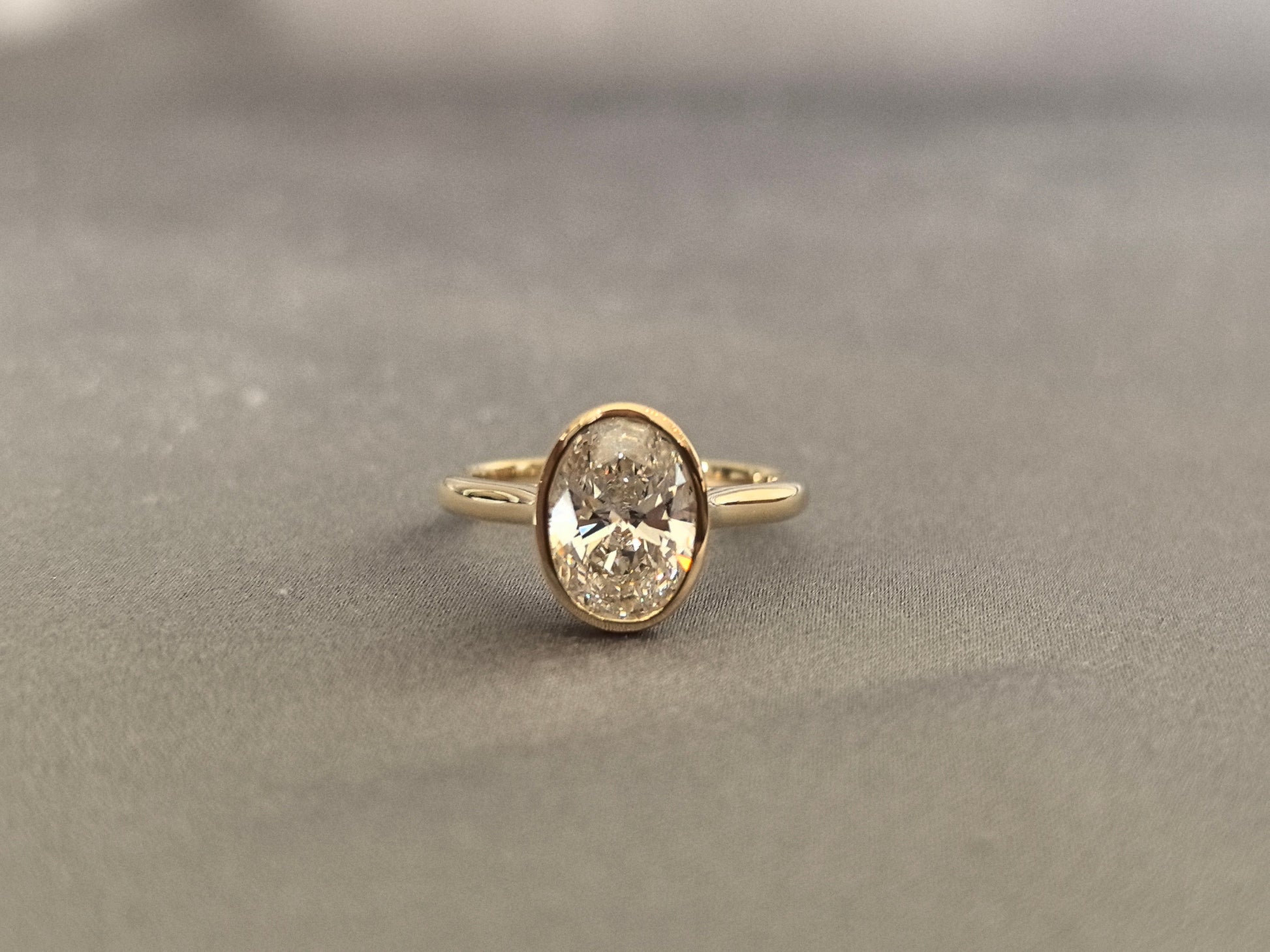 Oval-cut lab diamond solitaire ring - Bezel-set - Low-profile oval diamond
