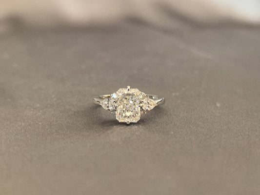 Three-stone emerald-cut lab diamond engagement ring - Pear-shaped sidestone - 4-Prong Set