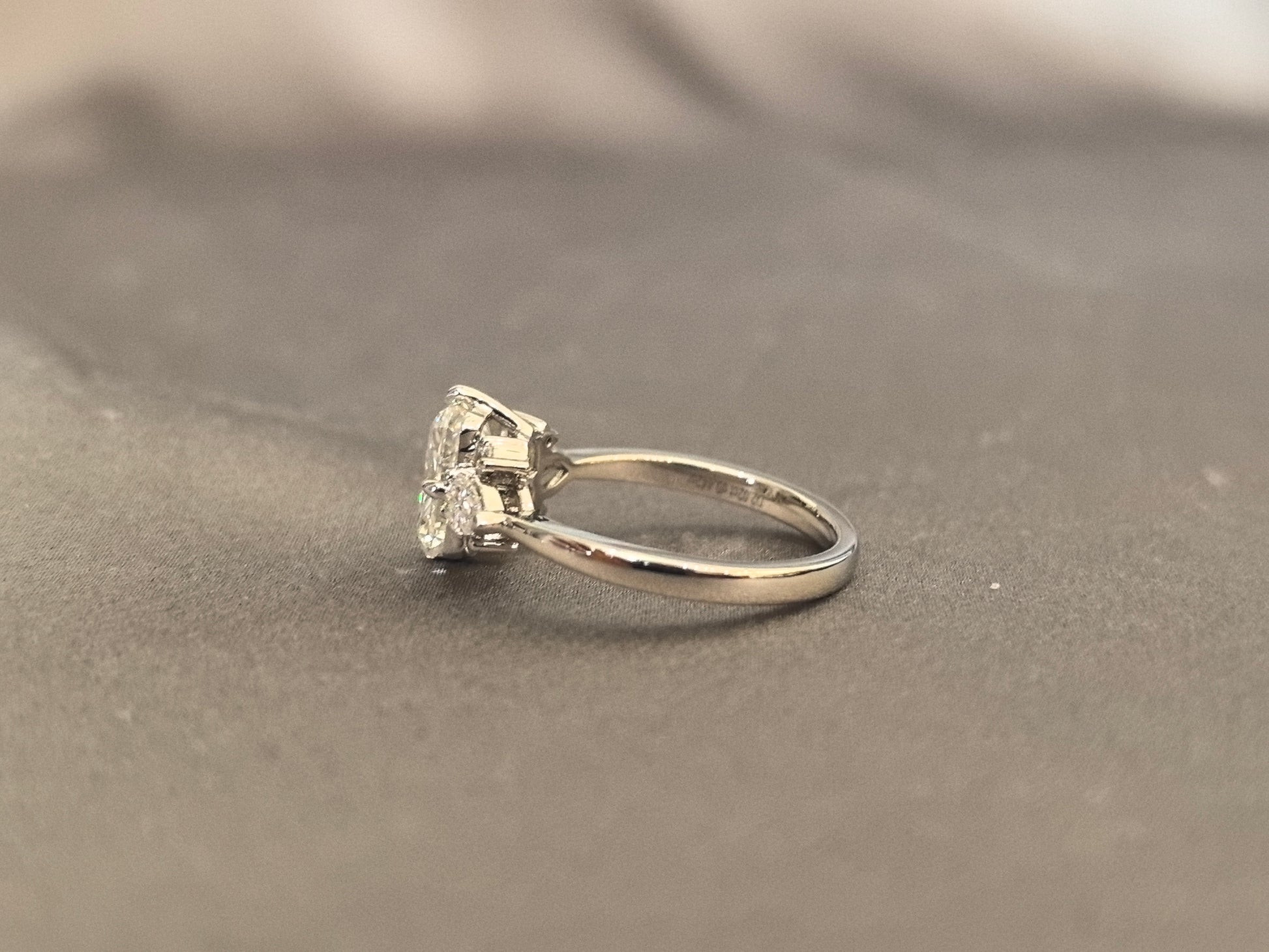 Three-stone emerald-cut lab diamond engagement ring - Pear-shaped sidestone - 4-Prong Set