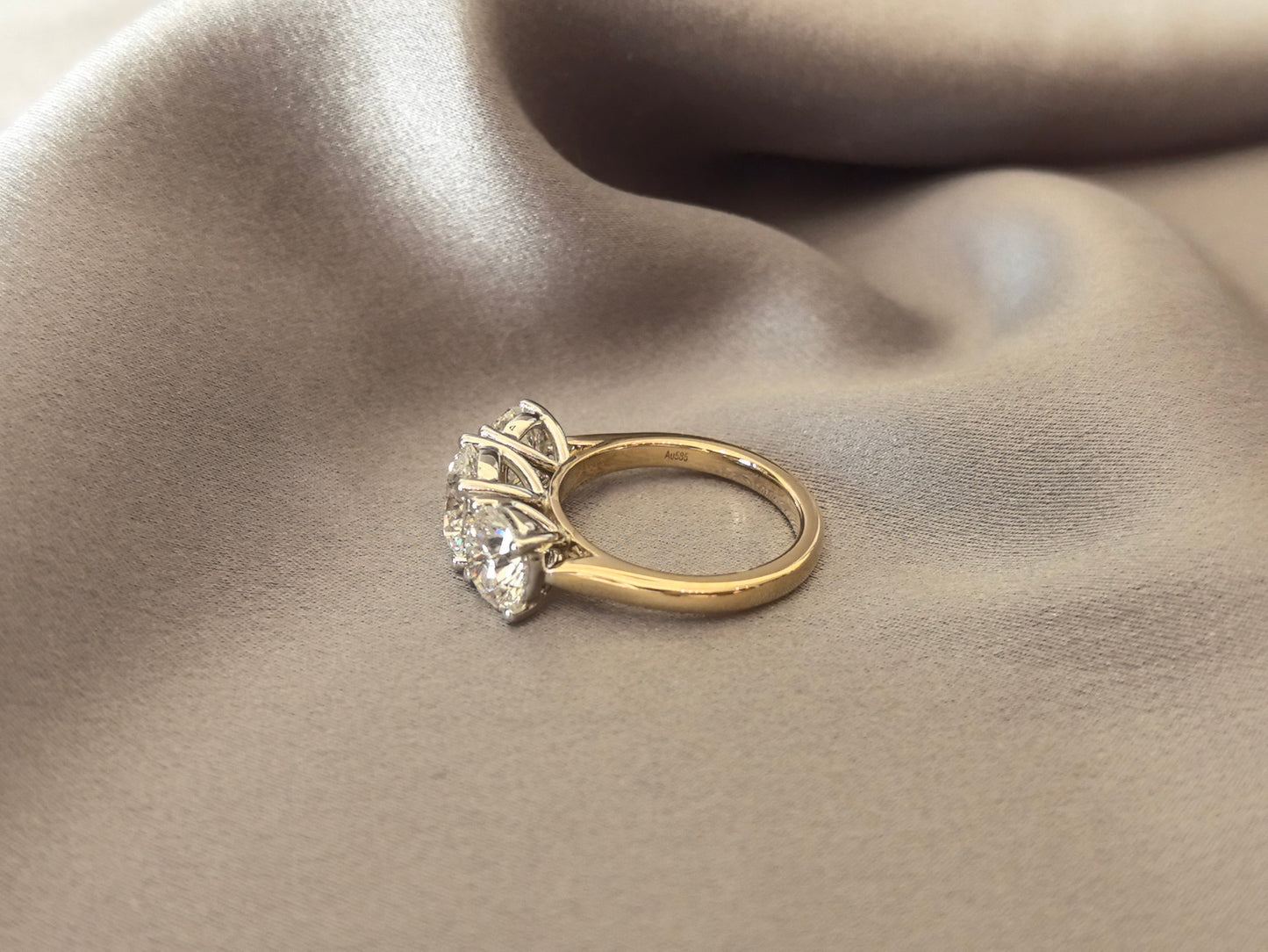 Round-Cut Lab-Grown Diamond Three-Stone Engagement Ring - Prong-Set - Striking Two-Tone Gold Color Contrast