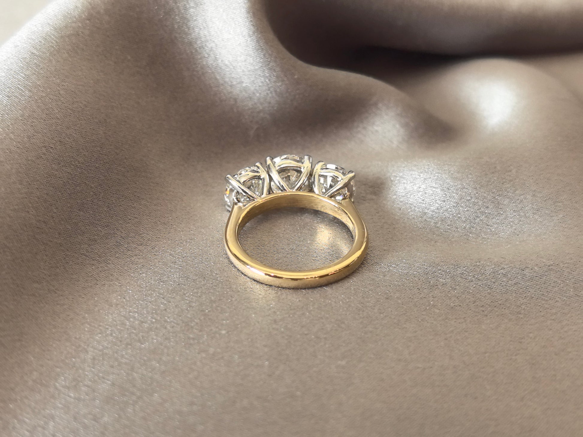 Round-Cut Lab-Grown Diamond Three-Stone Engagement Ring - Prong-Set - Striking Two-Tone Gold Color Contrast